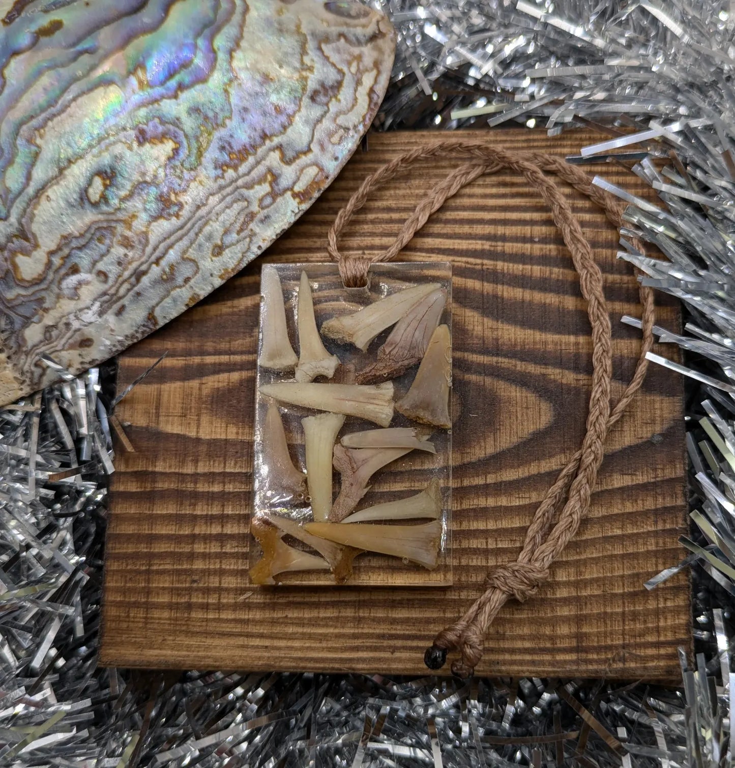 Fossilised sharks tooth in resin Christmas decoration.
