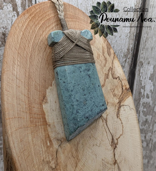 New Zealand Pounamu greenstone jade Hei Toki adze pendant with raw live edges.