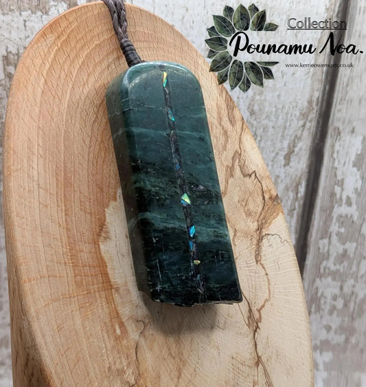 new Zealand pounamu serpentine with rainbownpāua inlay and raw edge.