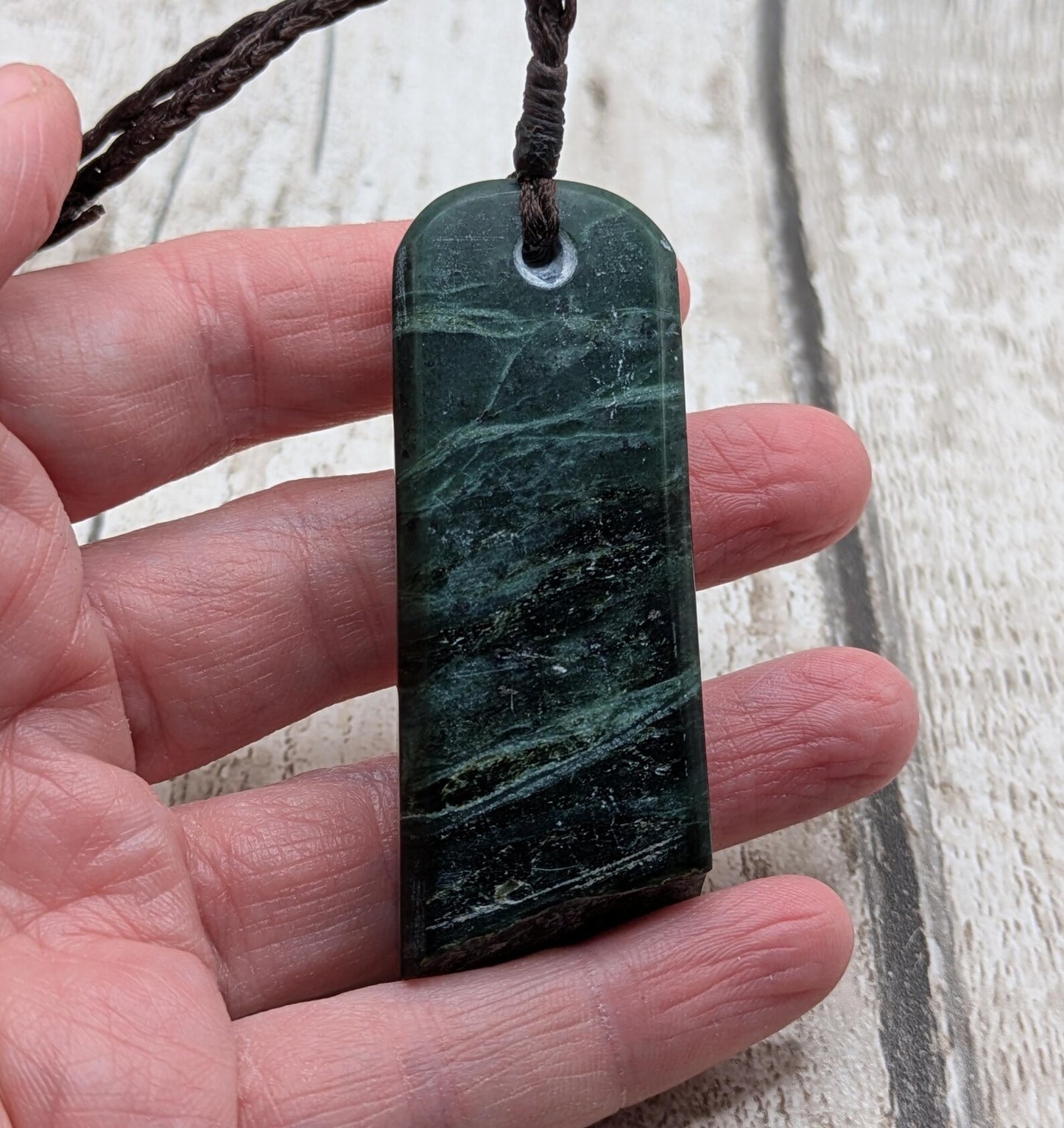 new Zealand pounamu serpentine with rainbownpāua inlay and raw edge.