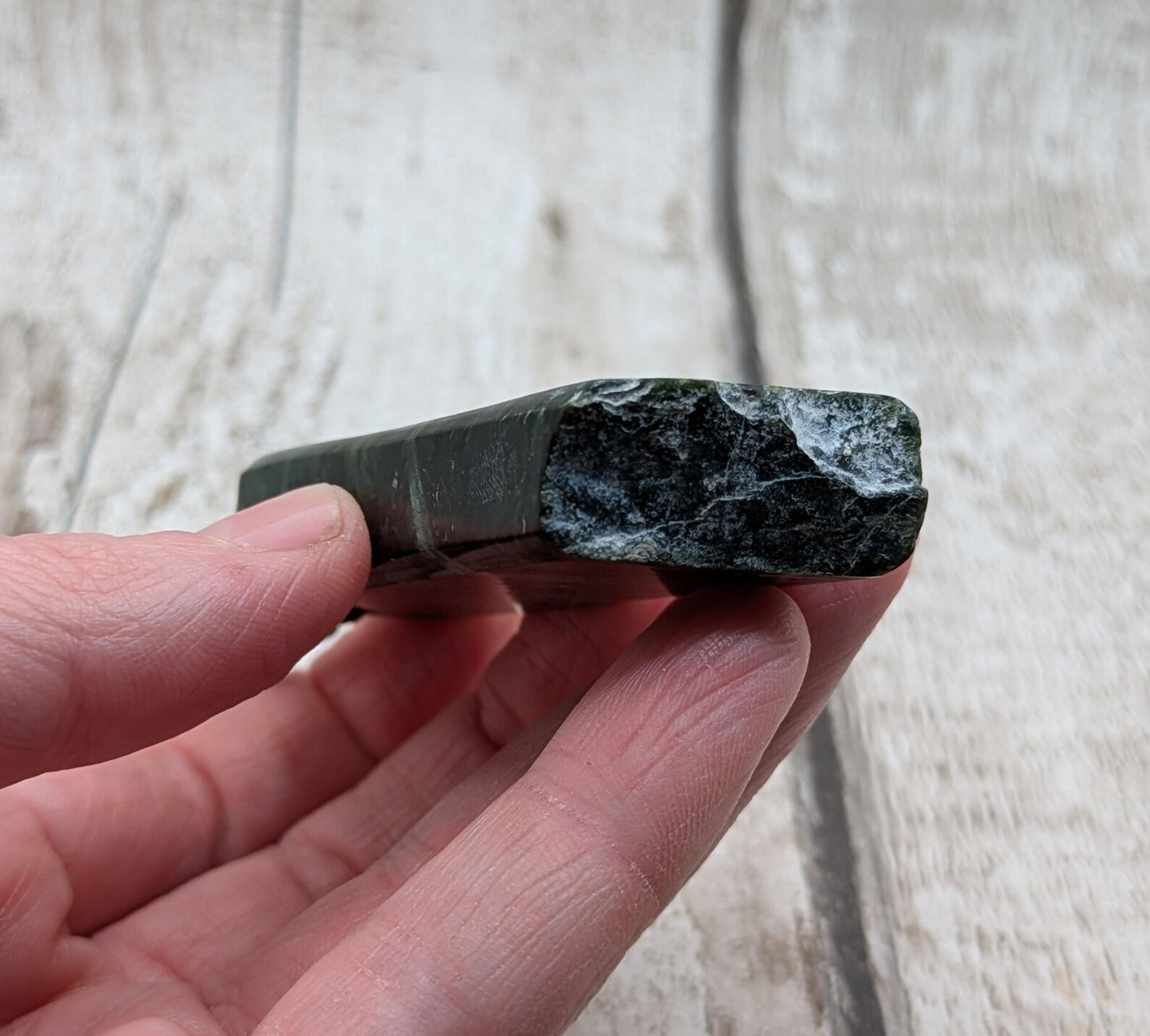 new Zealand pounamu serpentine with rainbownpāua inlay and raw edge.