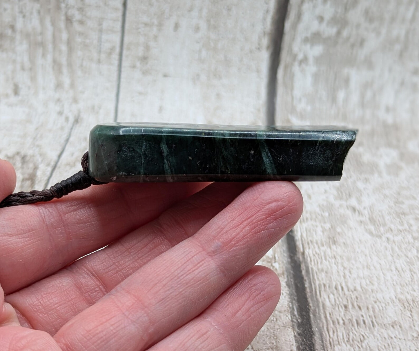 new Zealand pounamu serpentine with rainbownpāua inlay and raw edge.