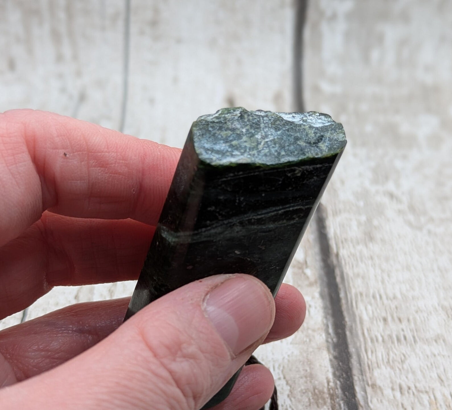 new Zealand pounamu serpentine with rainbownpāua inlay and raw edge.