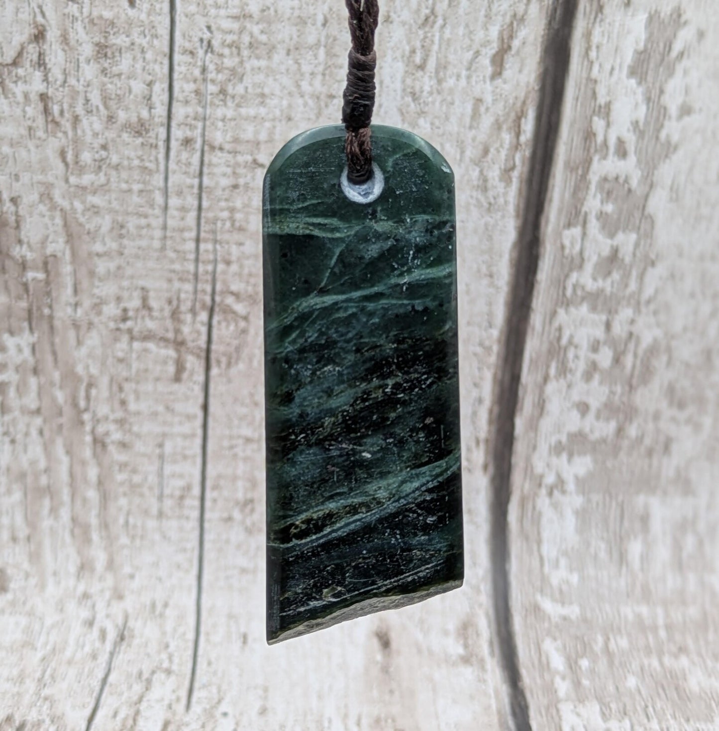 new Zealand pounamu serpentine with rainbownpāua inlay and raw edge.
