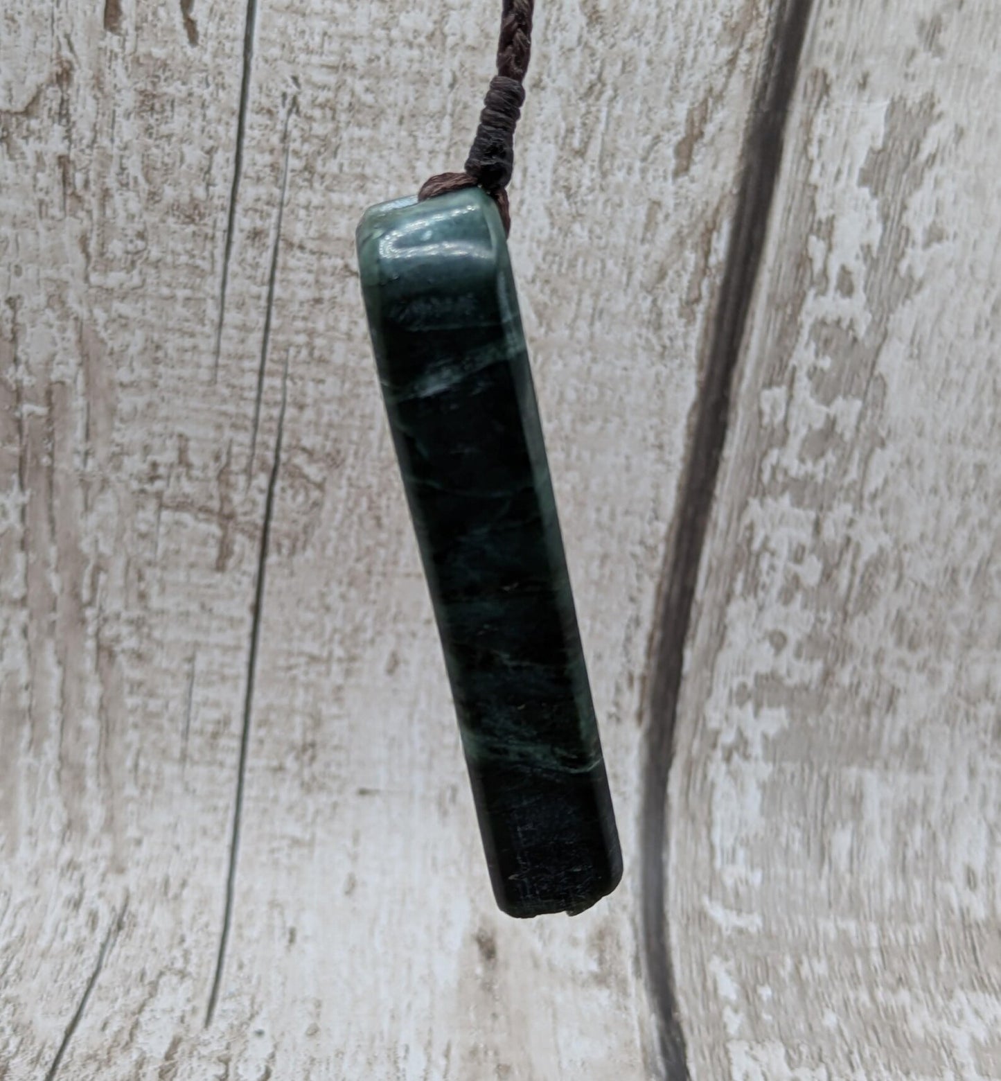 new Zealand pounamu serpentine with rainbownpāua inlay and raw edge.
