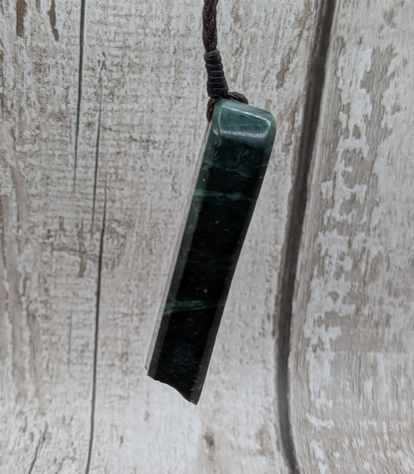 new Zealand pounamu serpentine with rainbownpāua inlay and raw edge.