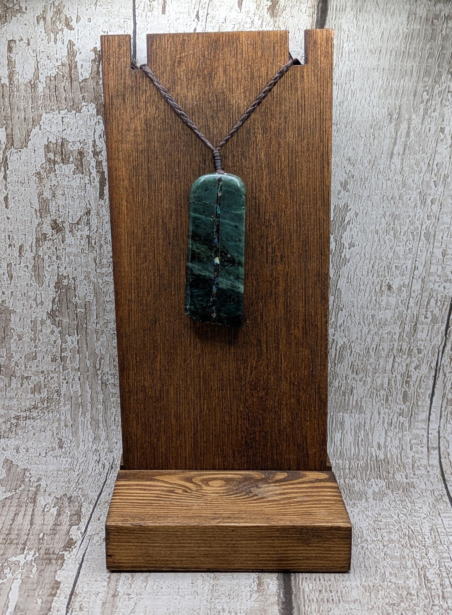 new Zealand pounamu serpentine with rainbownpāua inlay and raw edge.