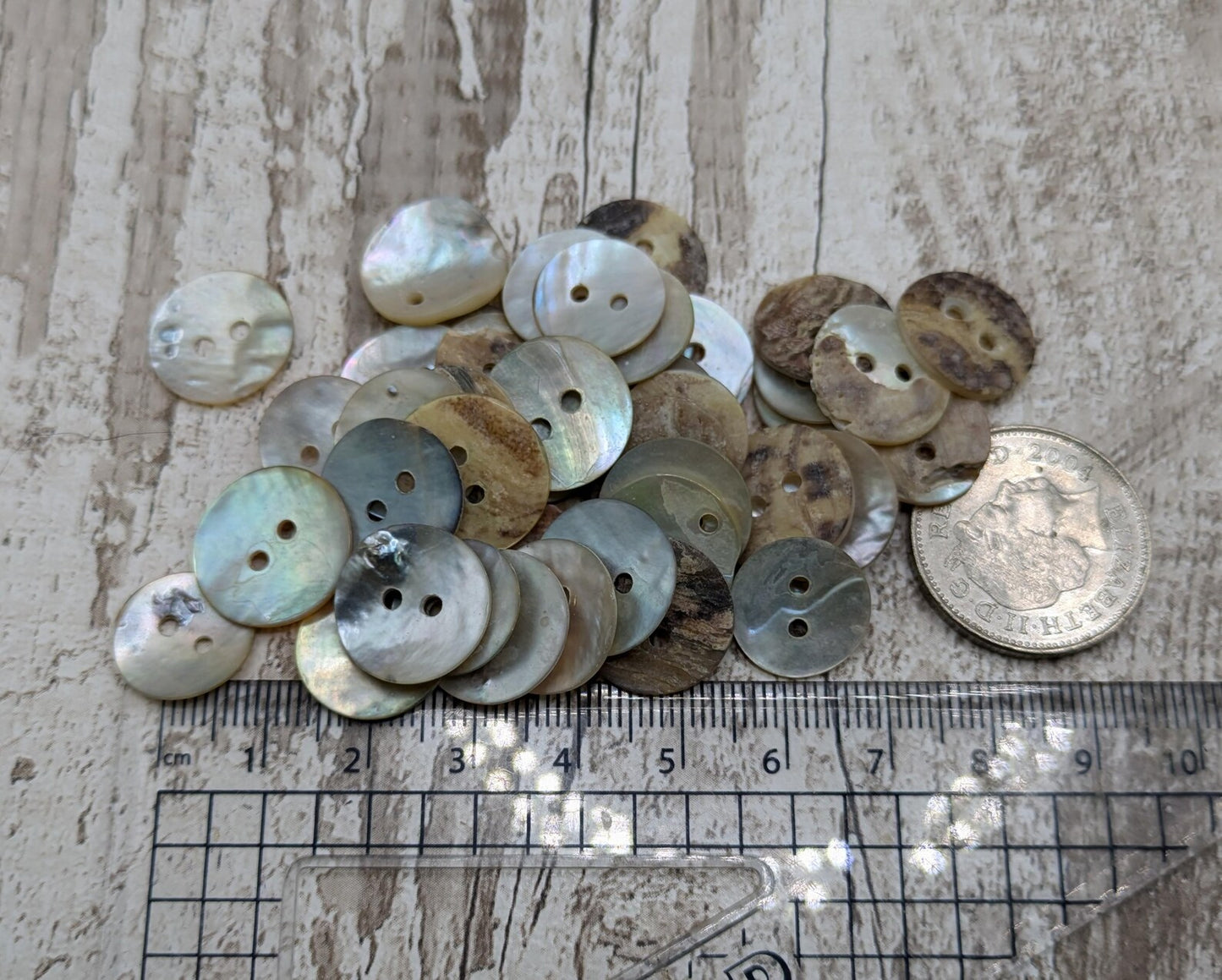 Medium abalone shell buttons.