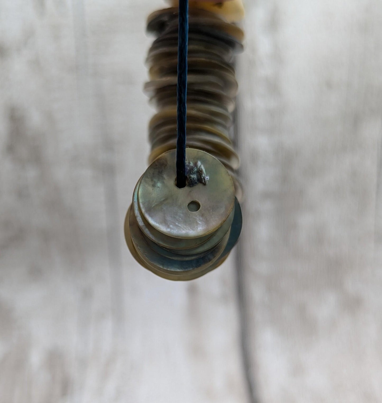 Medium abalone shell buttons.