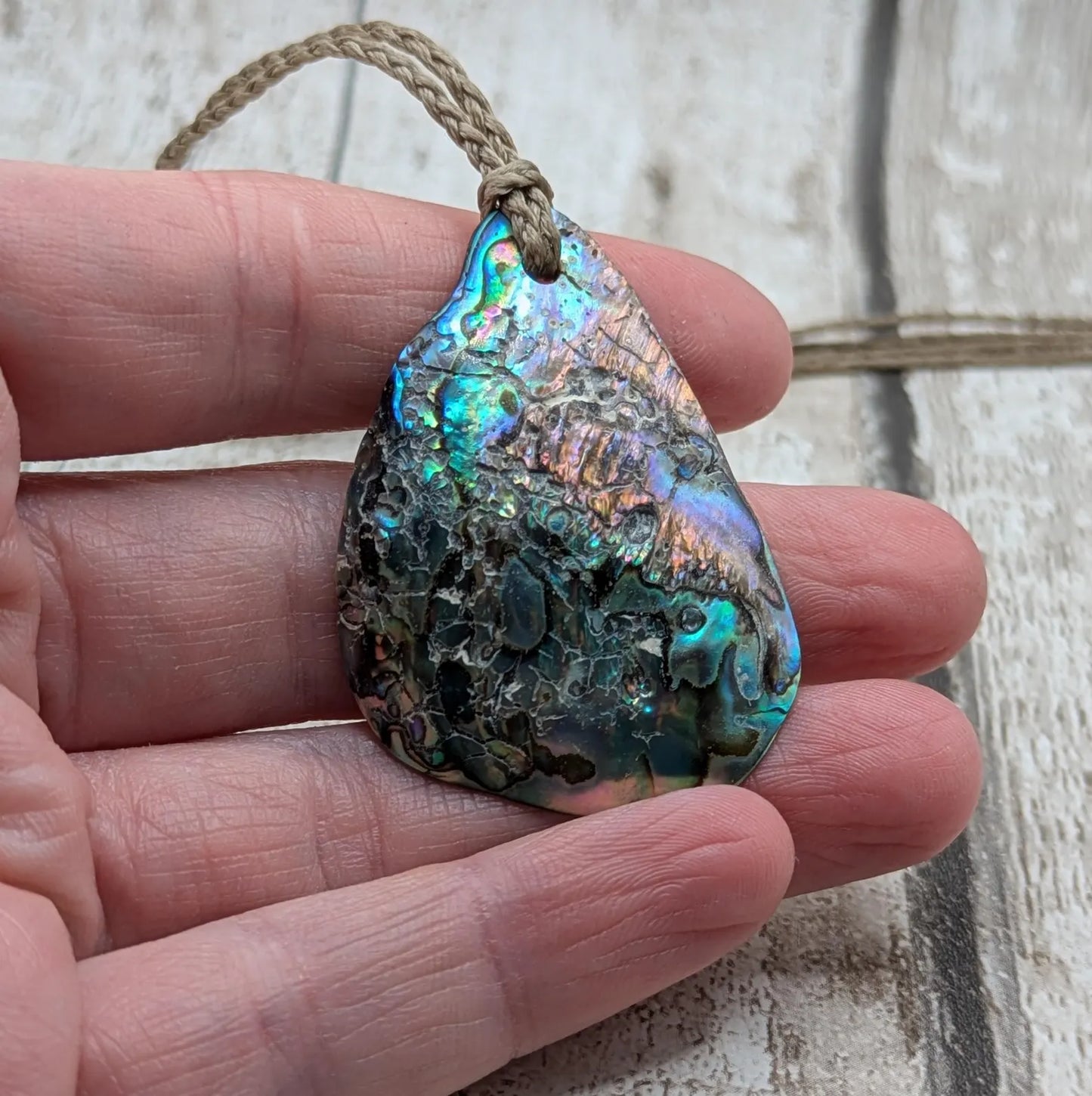 New Zealand free form wild tumbled rainbow Pāua pendant.