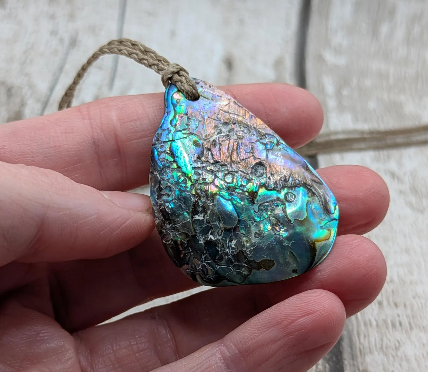 New Zealand free form wild tumbled rainbow Pāua pendant.