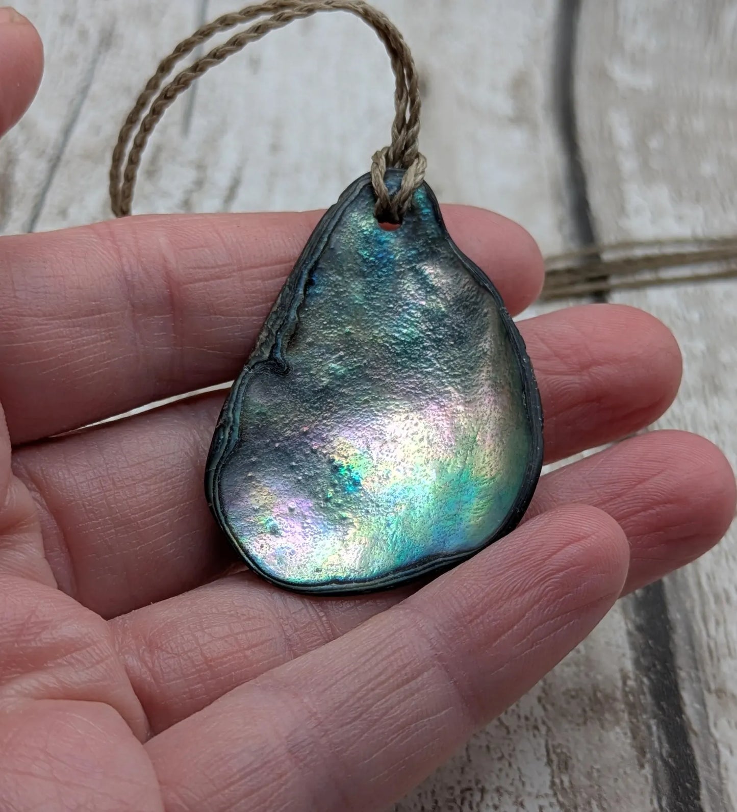 New Zealand free form wild tumbled rainbow Pāua pendant.