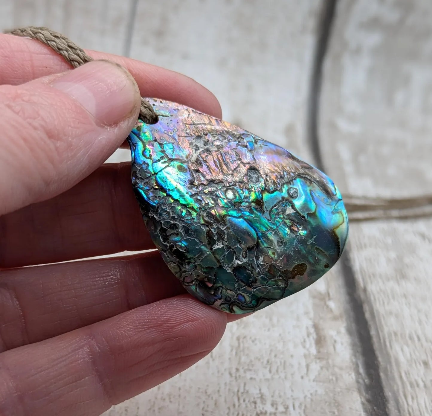 New Zealand free form wild tumbled rainbow Pāua pendant.