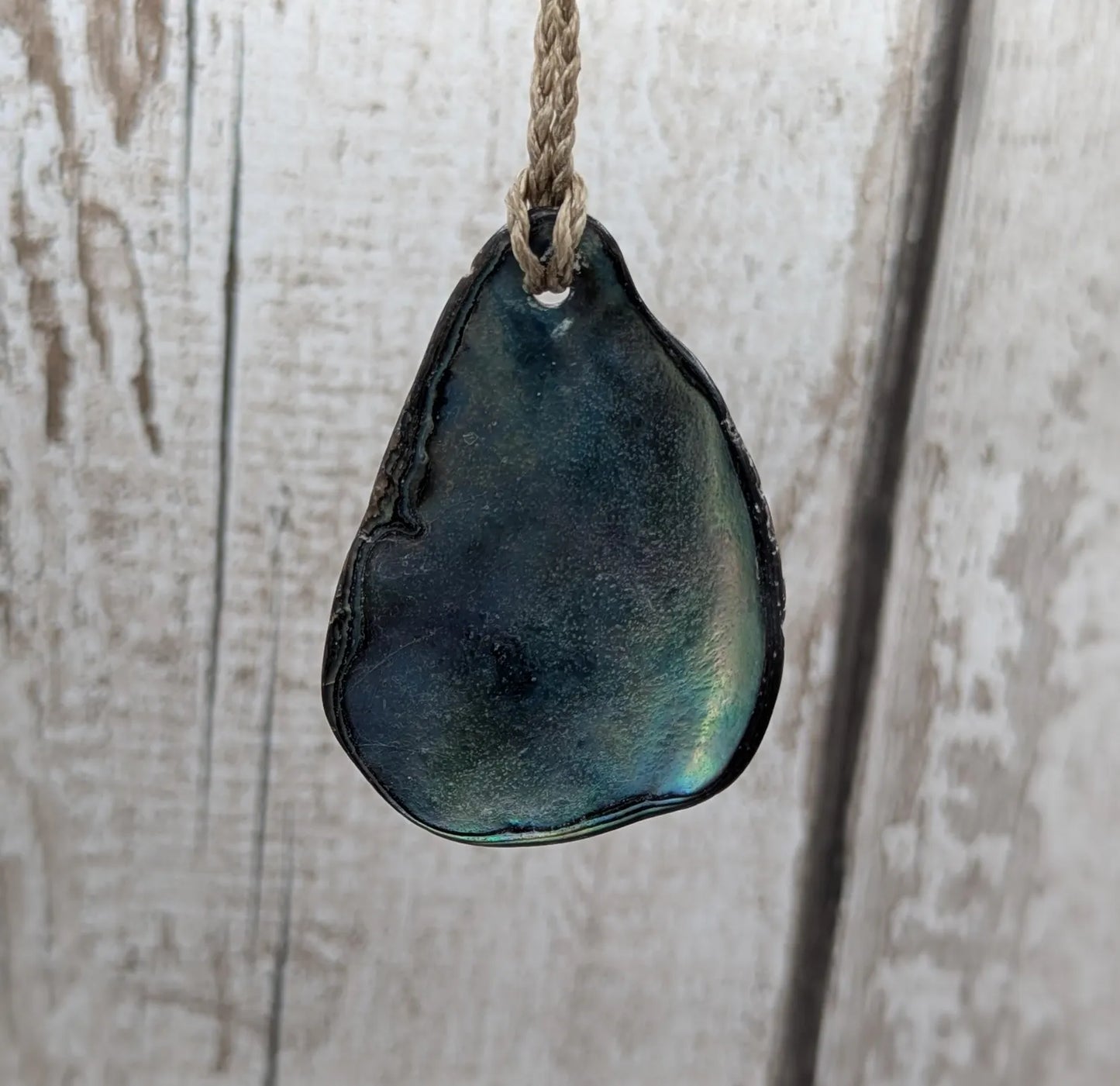 New Zealand free form wild tumbled rainbow Pāua pendant.