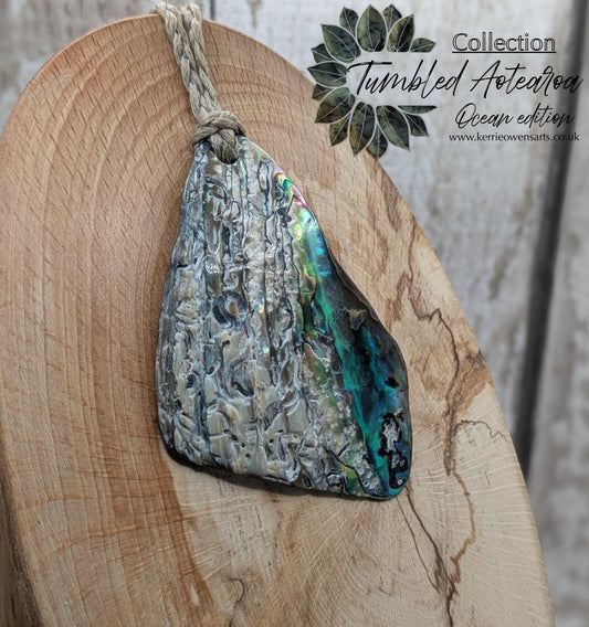 Naturally tumbled New Zealand rainbow Pāua abalone pendant.