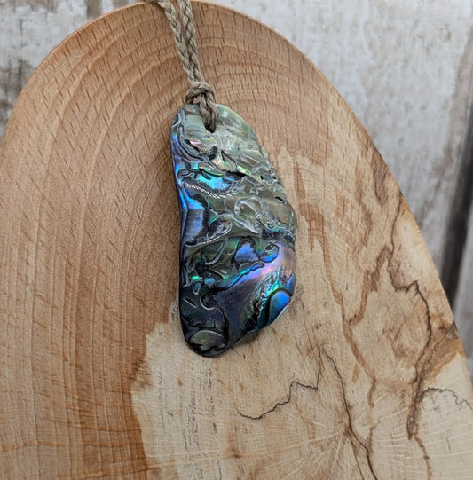 Naturally tumbled New Zealand rainbow Pāua abalone shell pendant