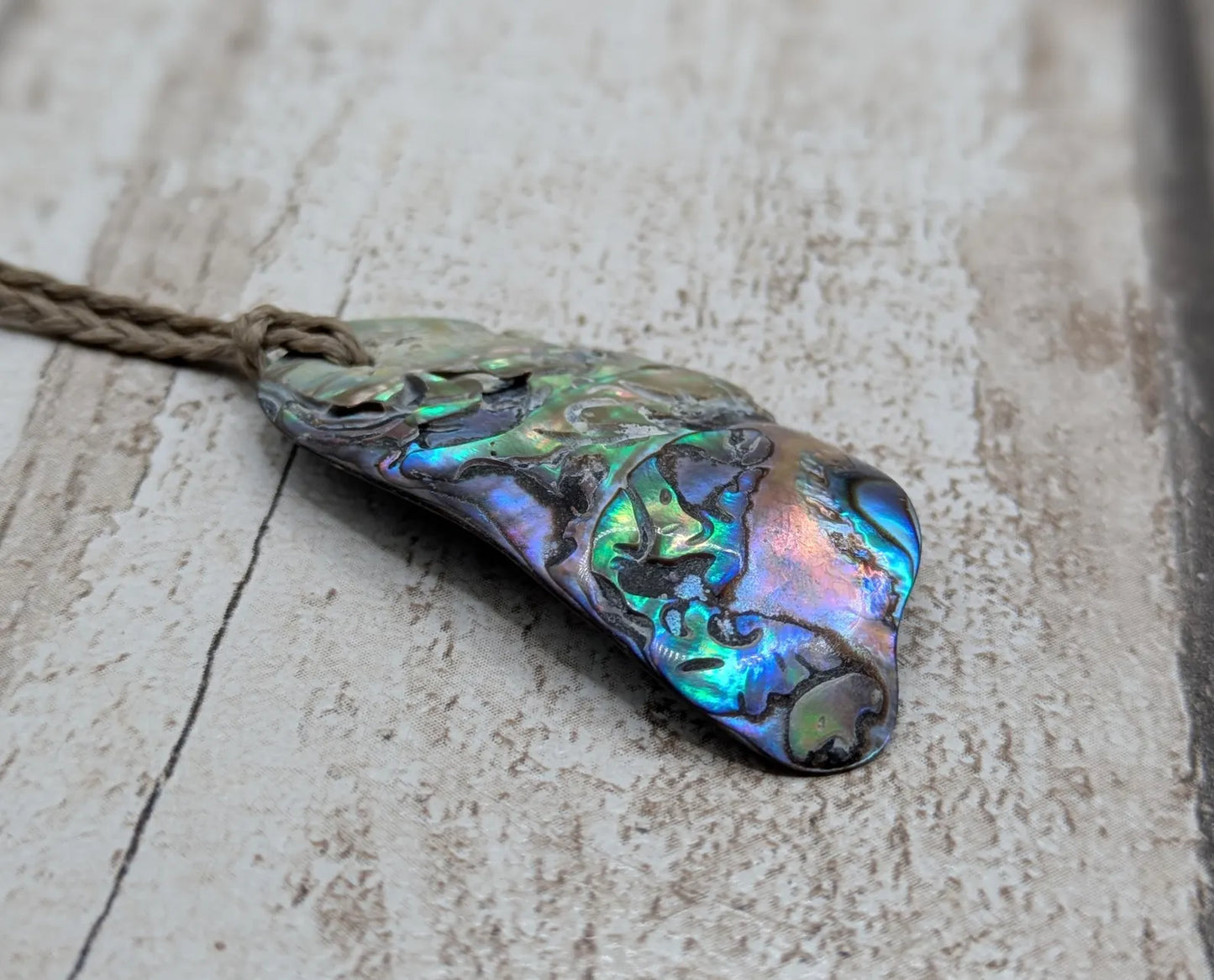 Naturally tumbled New Zealand rainbow Pāua abalone shell pendant