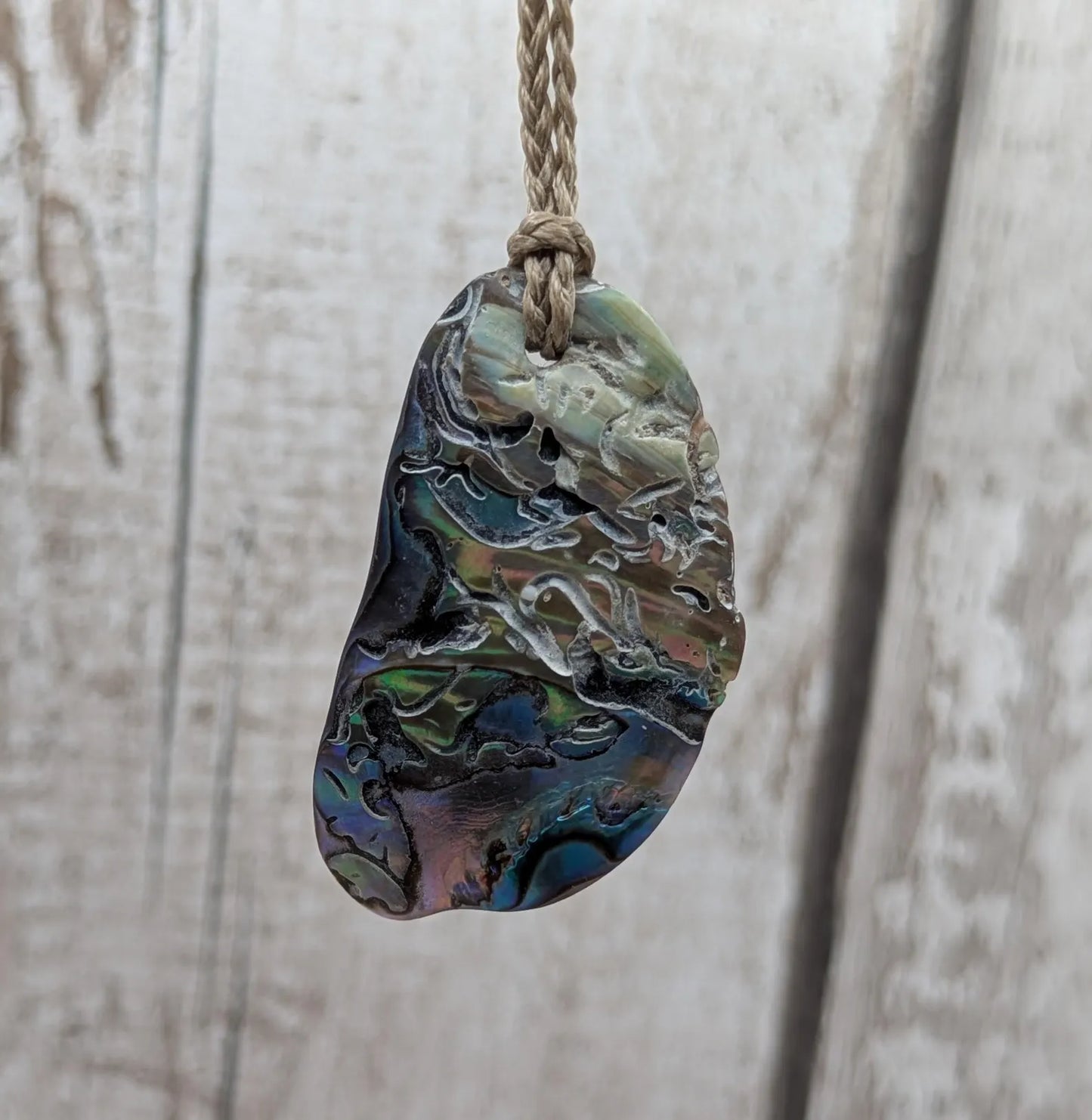 Naturally tumbled New Zealand rainbow Pāua abalone shell pendant