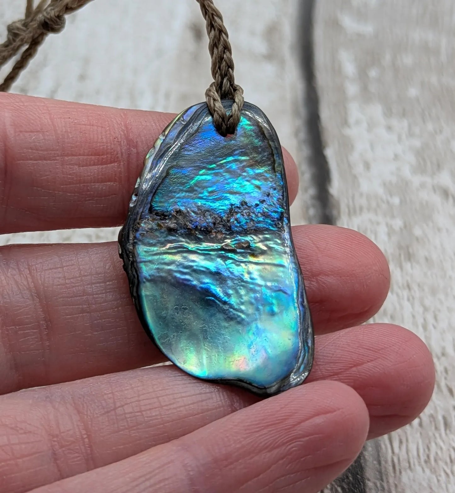 Naturally tumbled New Zealand rainbow Pāua abalone shell pendant