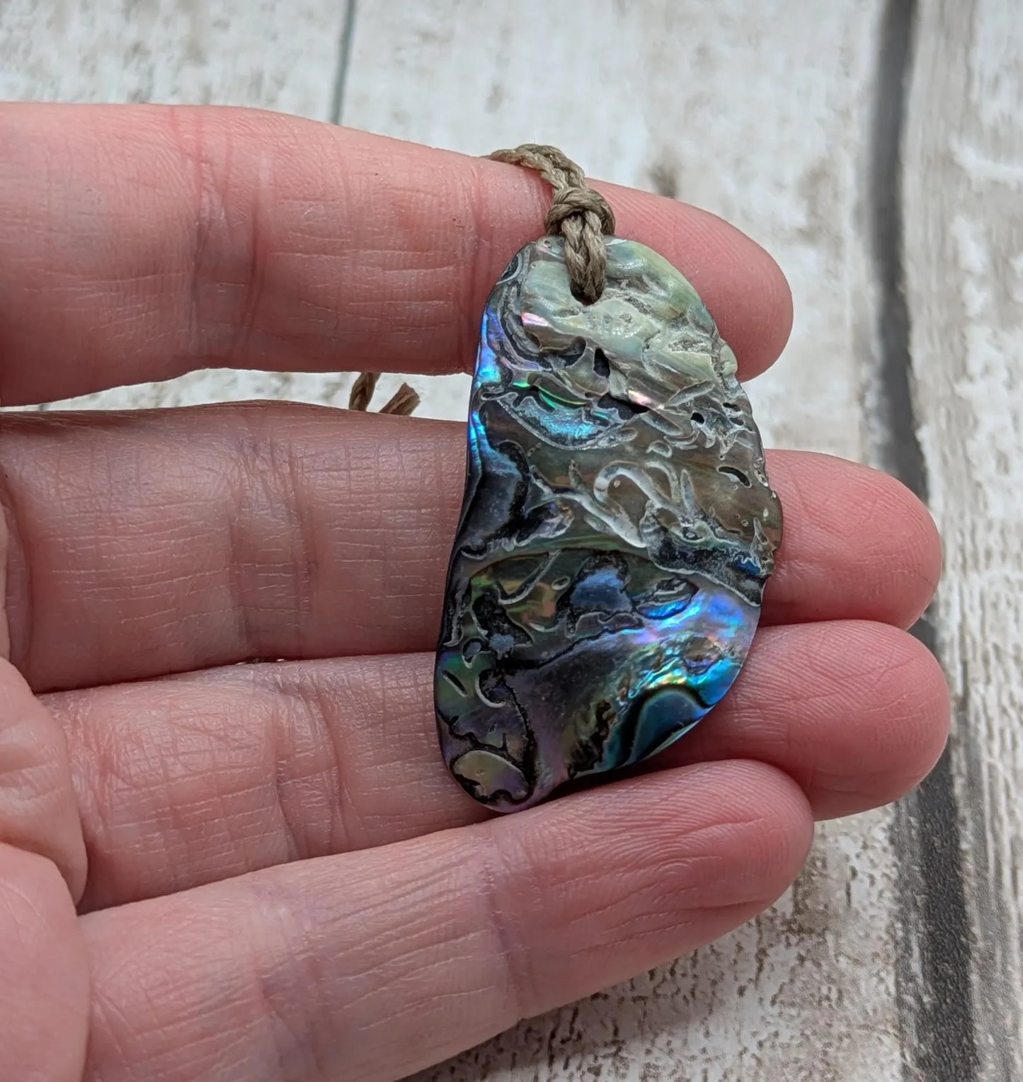 Naturally tumbled New Zealand rainbow Pāua abalone shell pendant