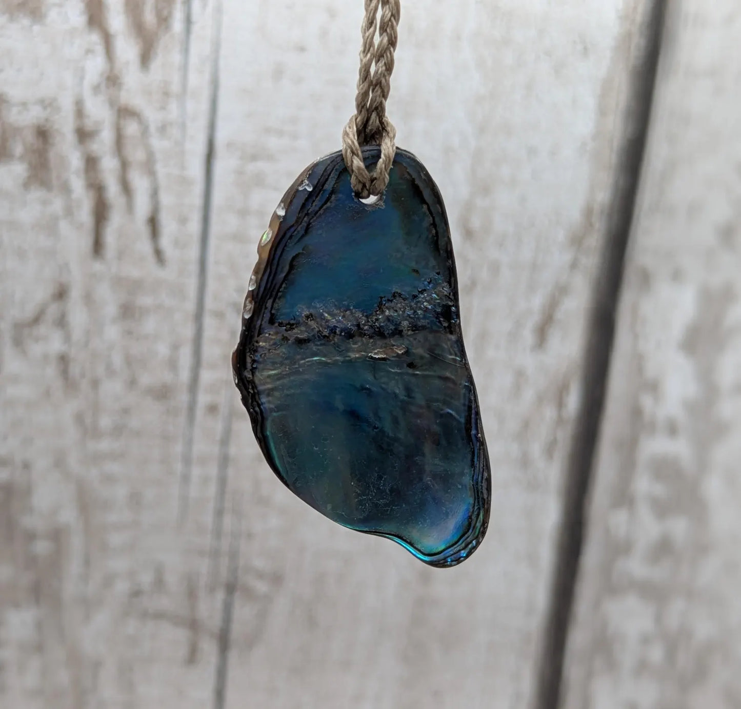 Naturally tumbled New Zealand rainbow Pāua abalone shell pendant