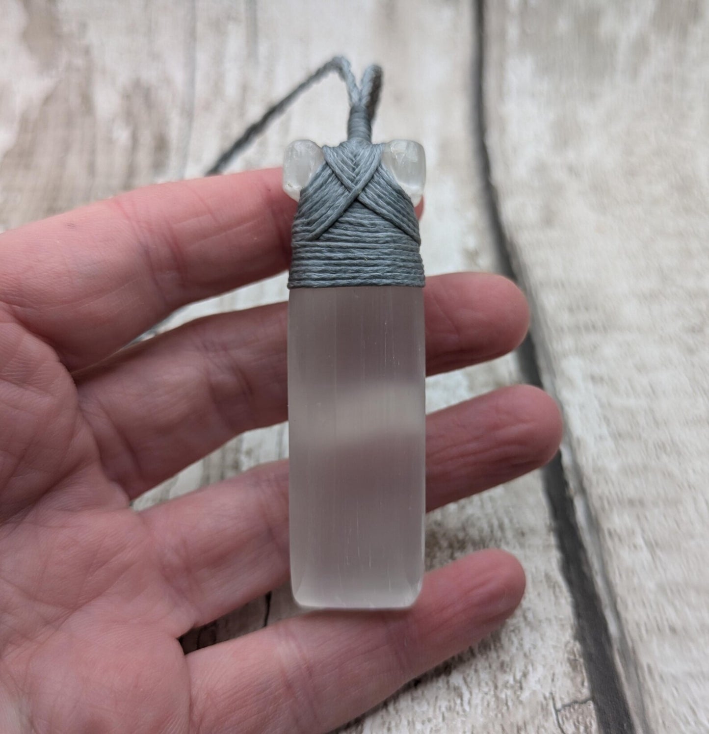 Selenite satin spar Hei Toki adze pendant.