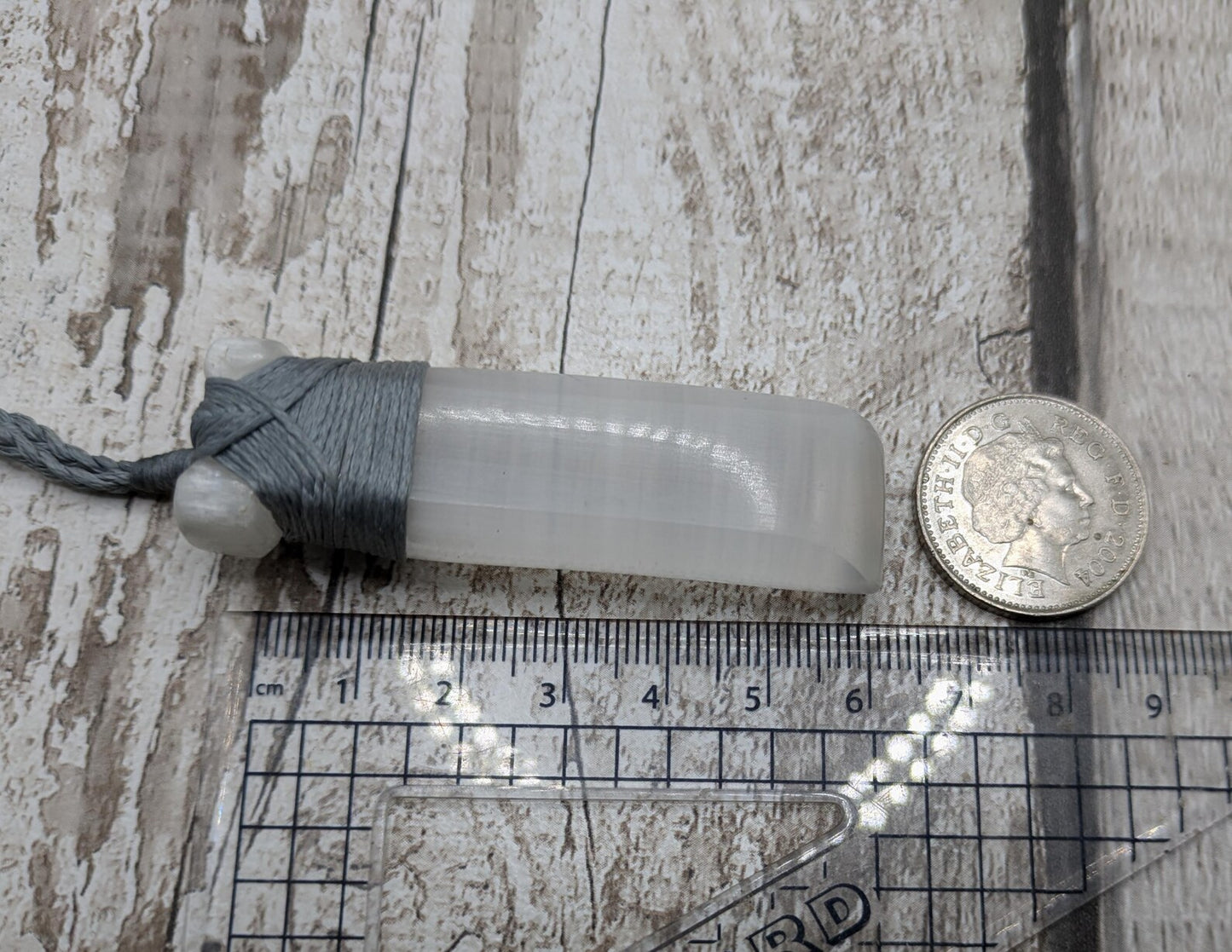 Selenite satin spar Hei Toki adze pendant.