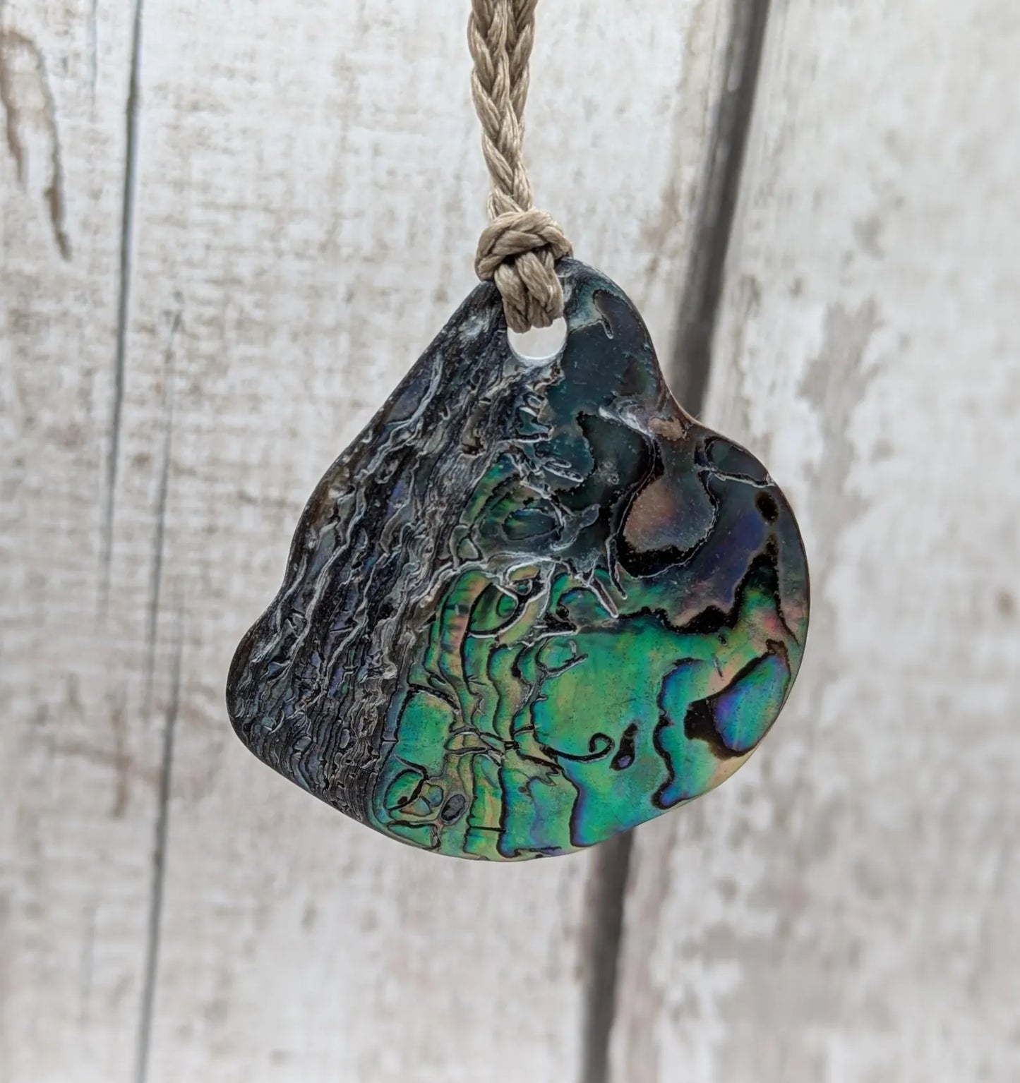 Naturally tumbled New Zealand rainbow Pāua pendant