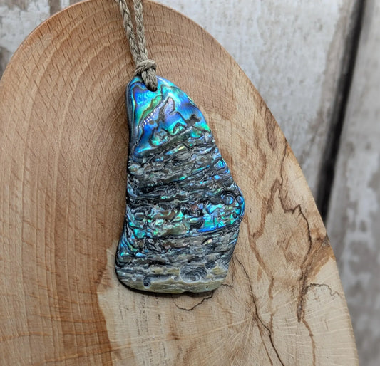 Naturally tumbled New Zealand rainbow Pāua abalone shell pendant