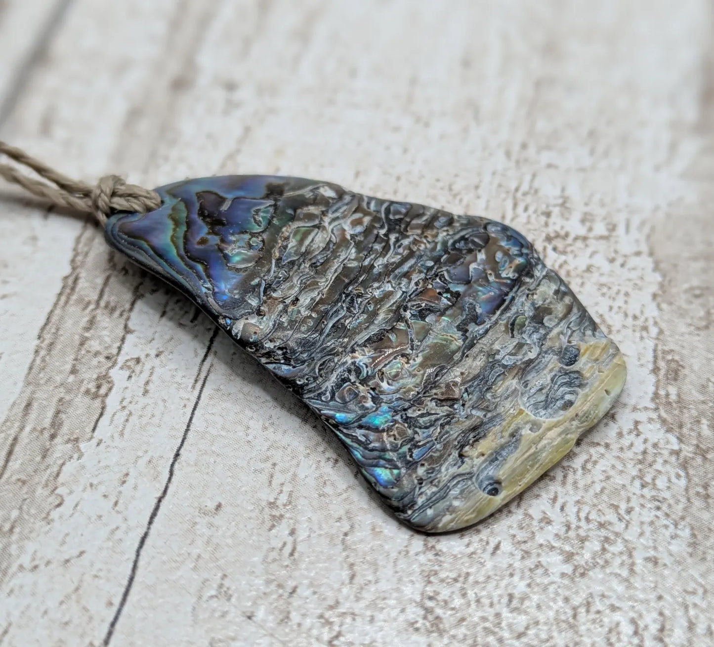 Naturally tumbled New Zealand rainbow Pāua abalone shell pendant