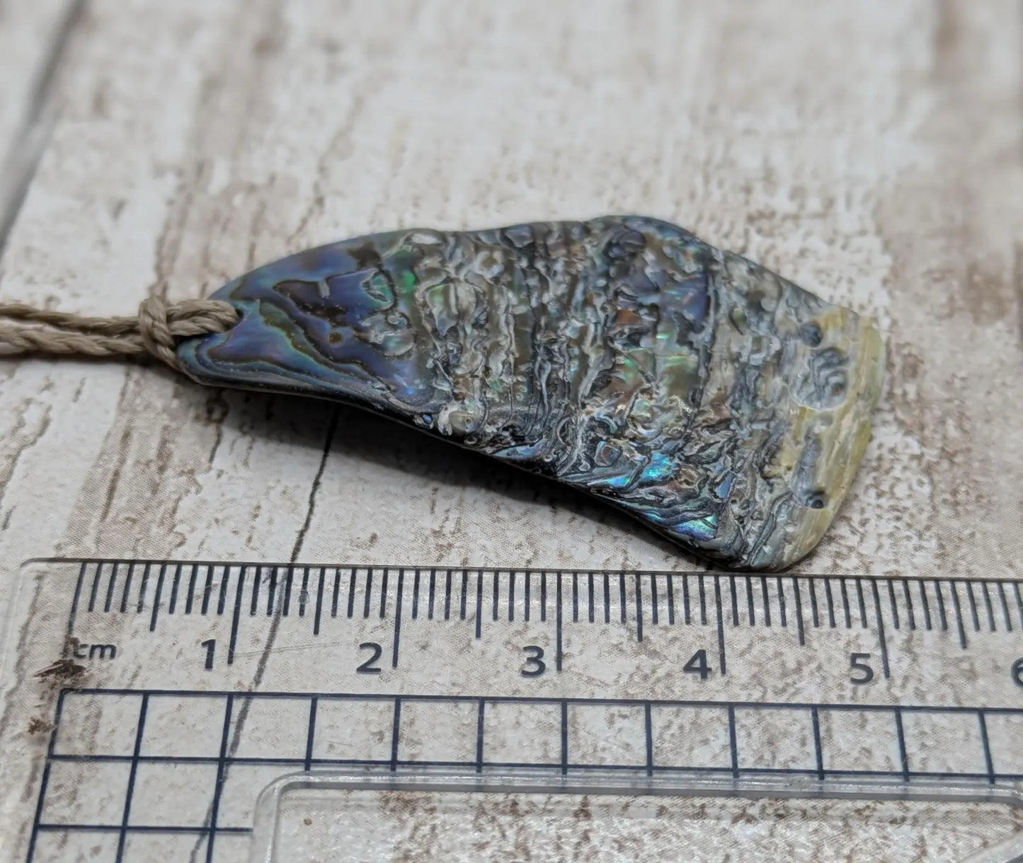 Naturally tumbled New Zealand rainbow Pāua abalone shell pendant