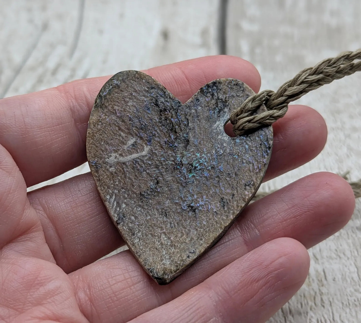 Hand carved New Zealand rainbow Pāua shell heart shaped pendant.