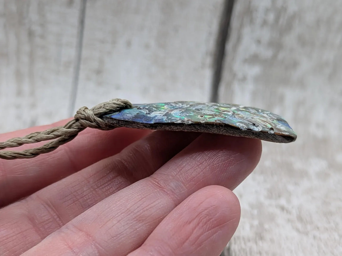 Hand carved New Zealand rainbow Pāua shell heart shaped pendant.