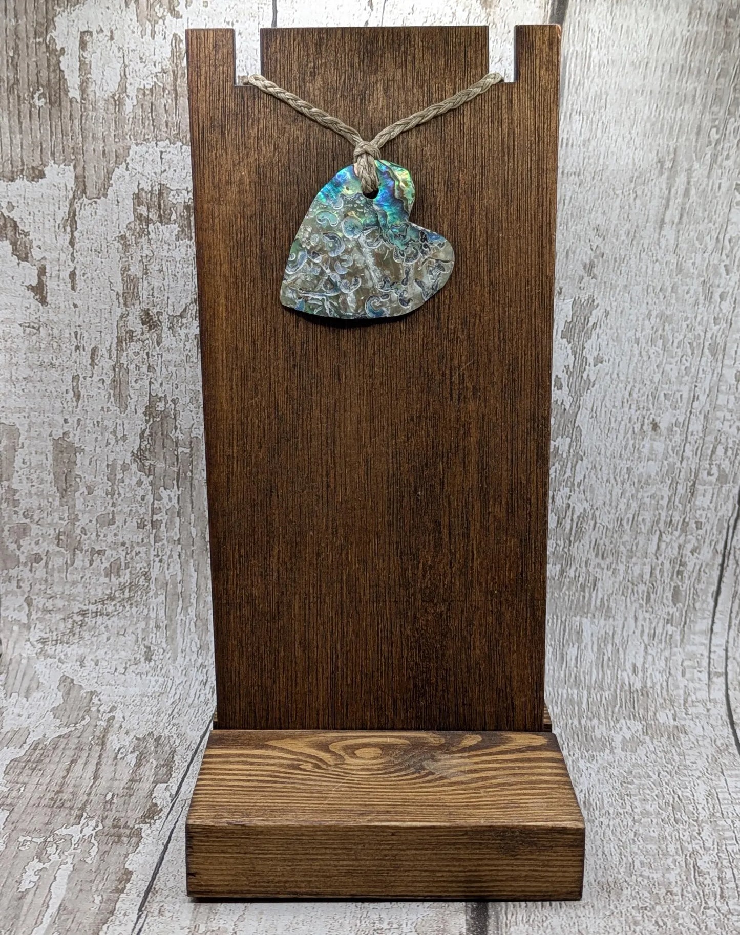 Hand carved New Zealand rainbow Pāua shell heart shaped pendant.
