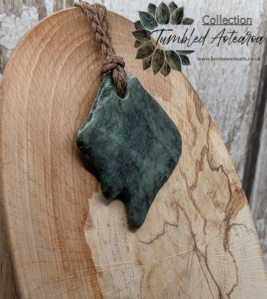 Tumble polished New Zealand Pounamu greenstone pebble pendant.