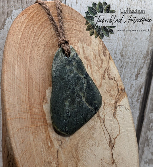 Tumbled polished New Zealand Pounamu greenstone pebble pendant.