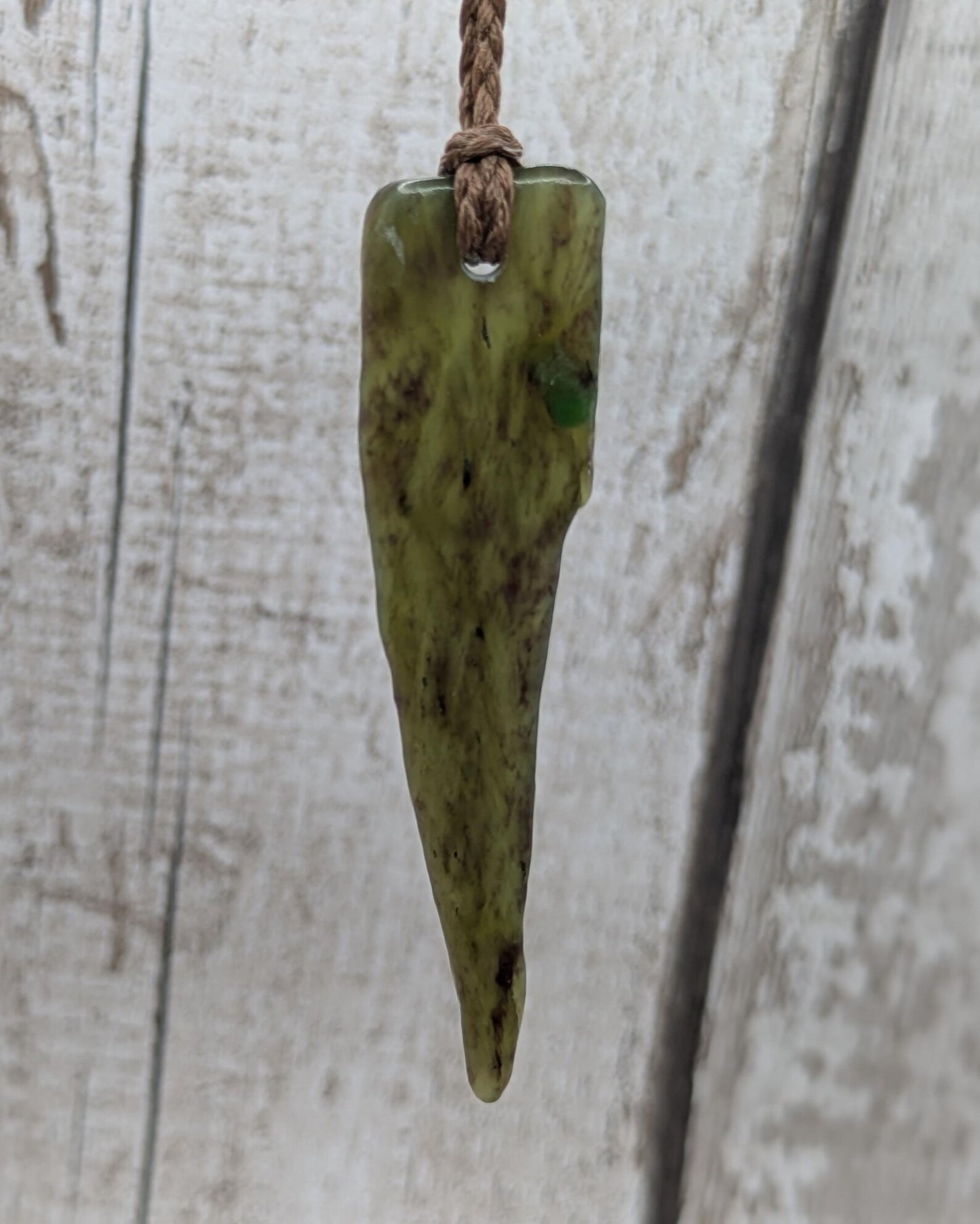 Tumble polished New Zealand Pounamu Jade pendant.