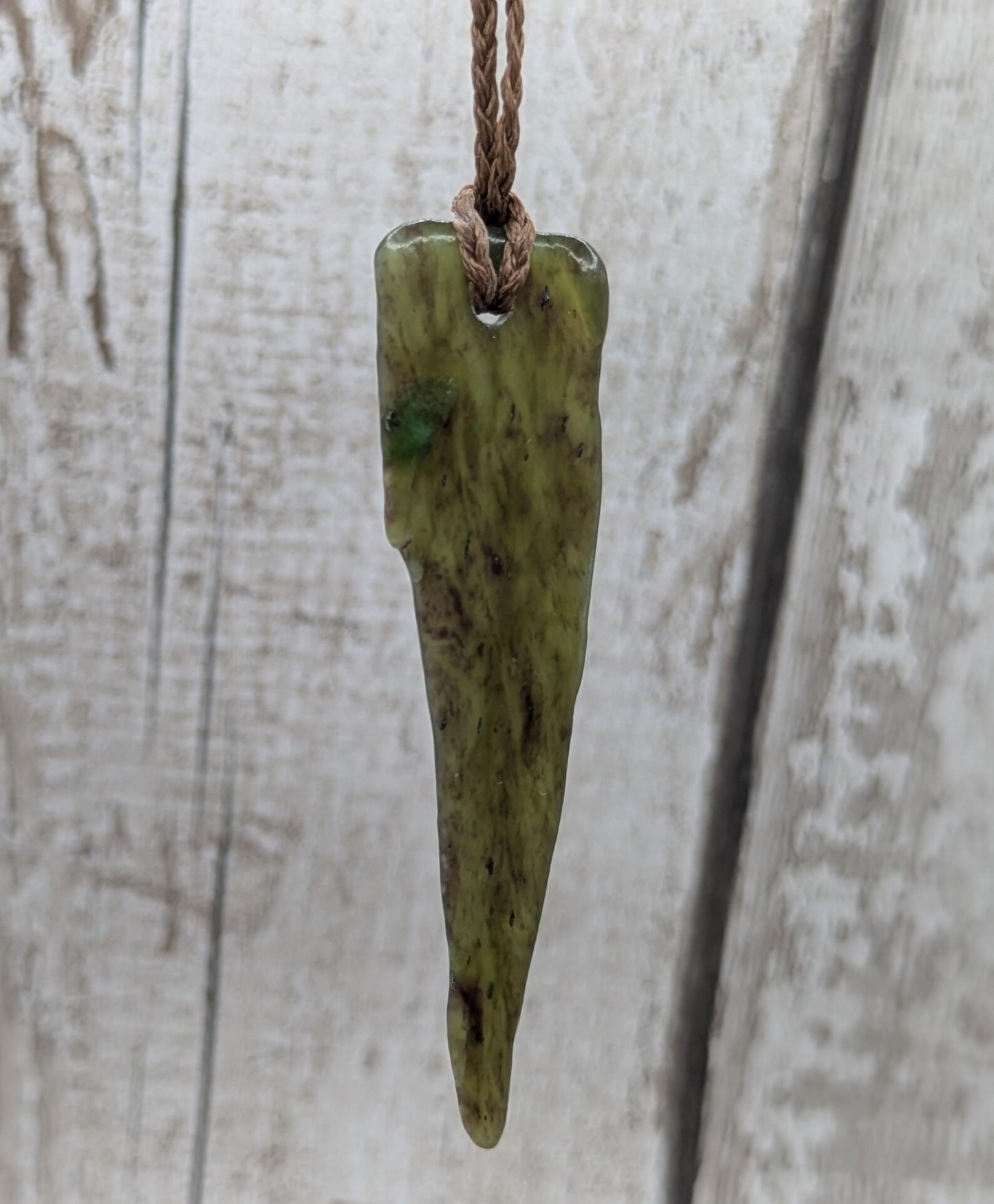 Tumble polished New Zealand Pounamu Jade pendant.