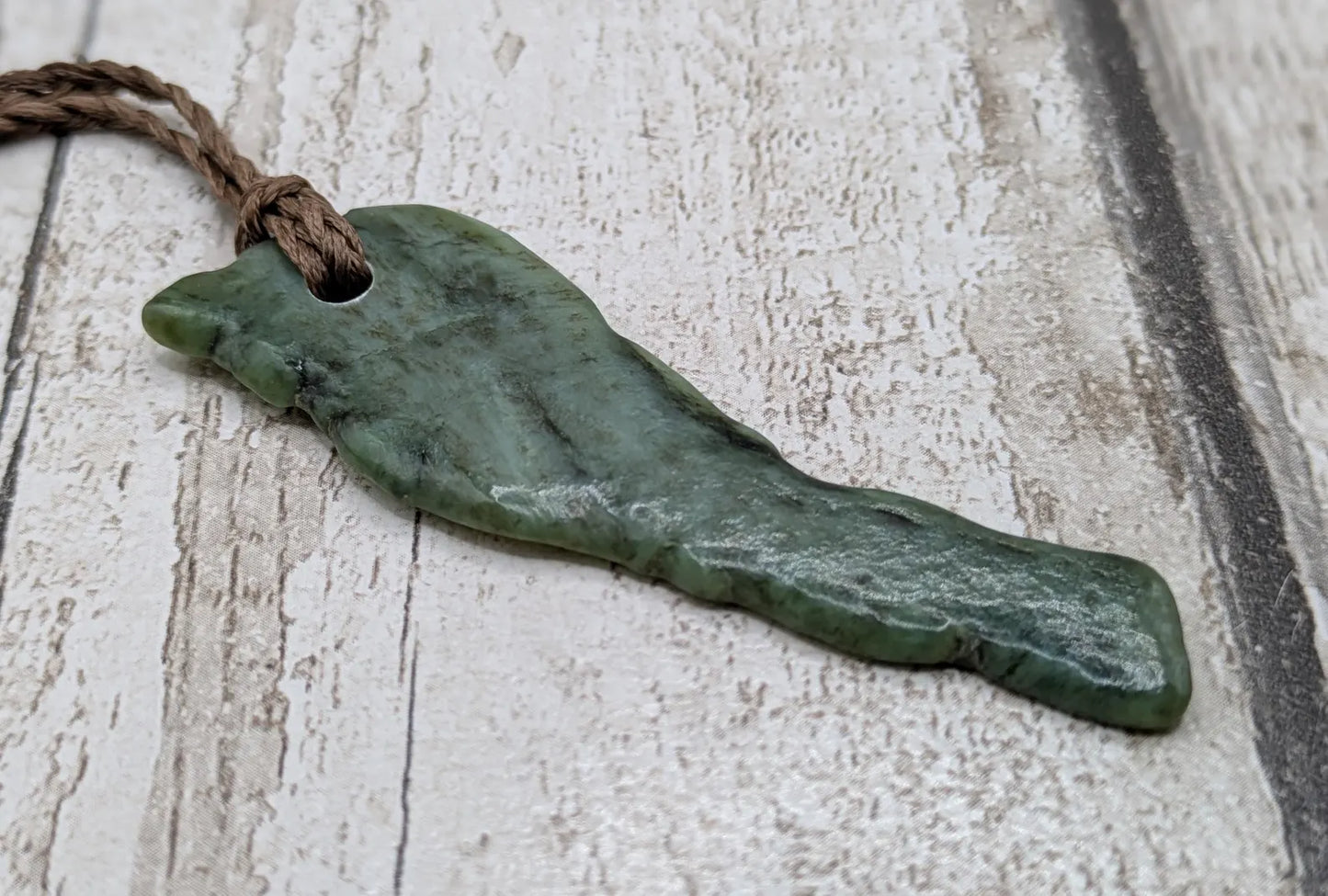 tumble polished New Zealand pounamu greenstone jade pendant.