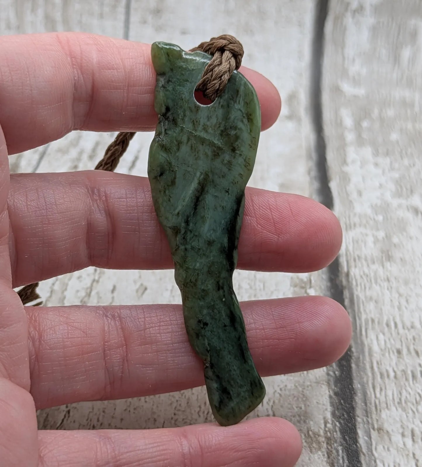 tumble polished New Zealand pounamu greenstone jade pendant.