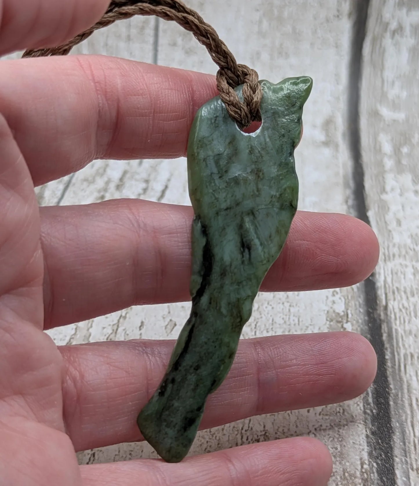 tumble polished New Zealand pounamu greenstone jade pendant.