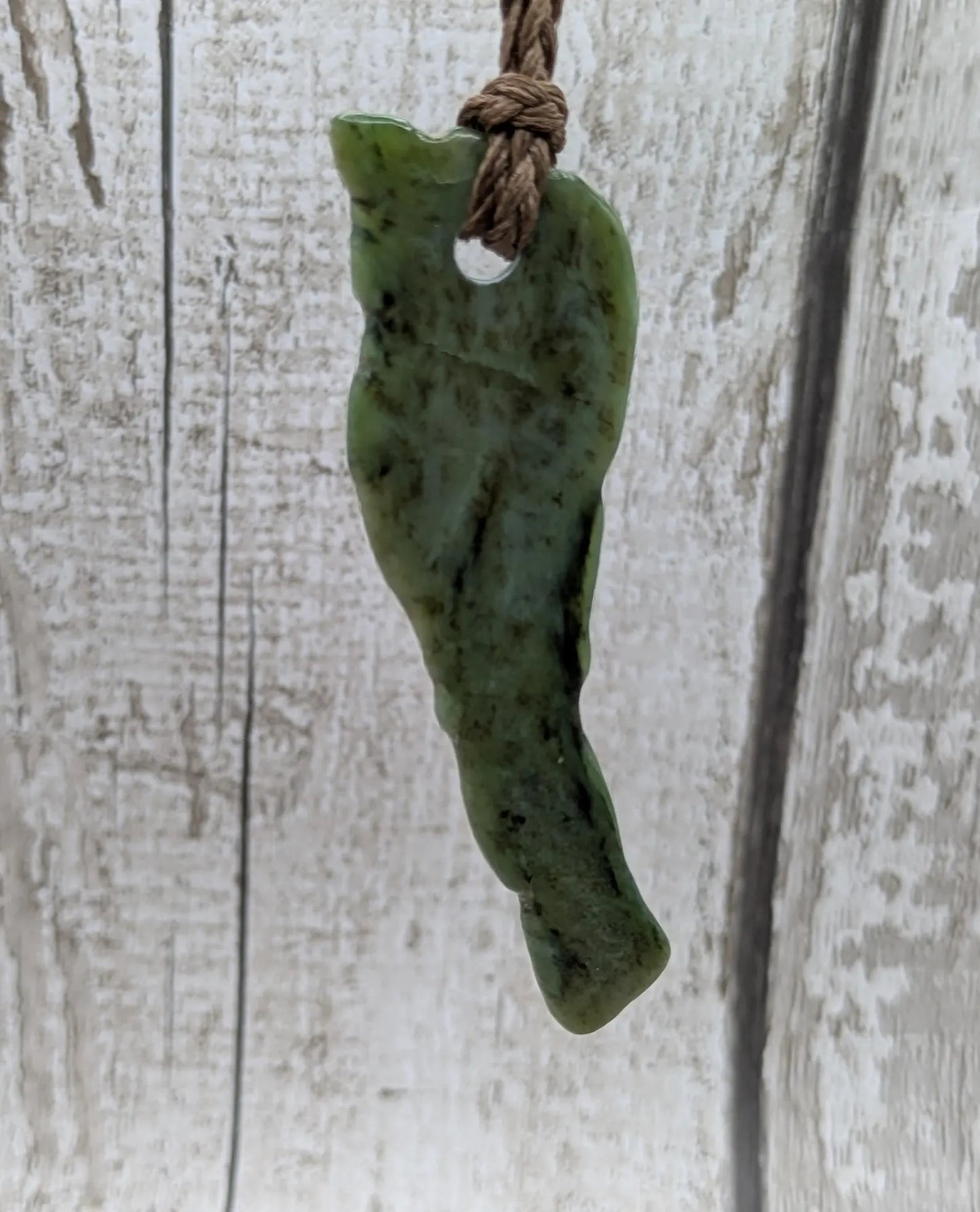 tumble polished New Zealand pounamu greenstone jade pendant.