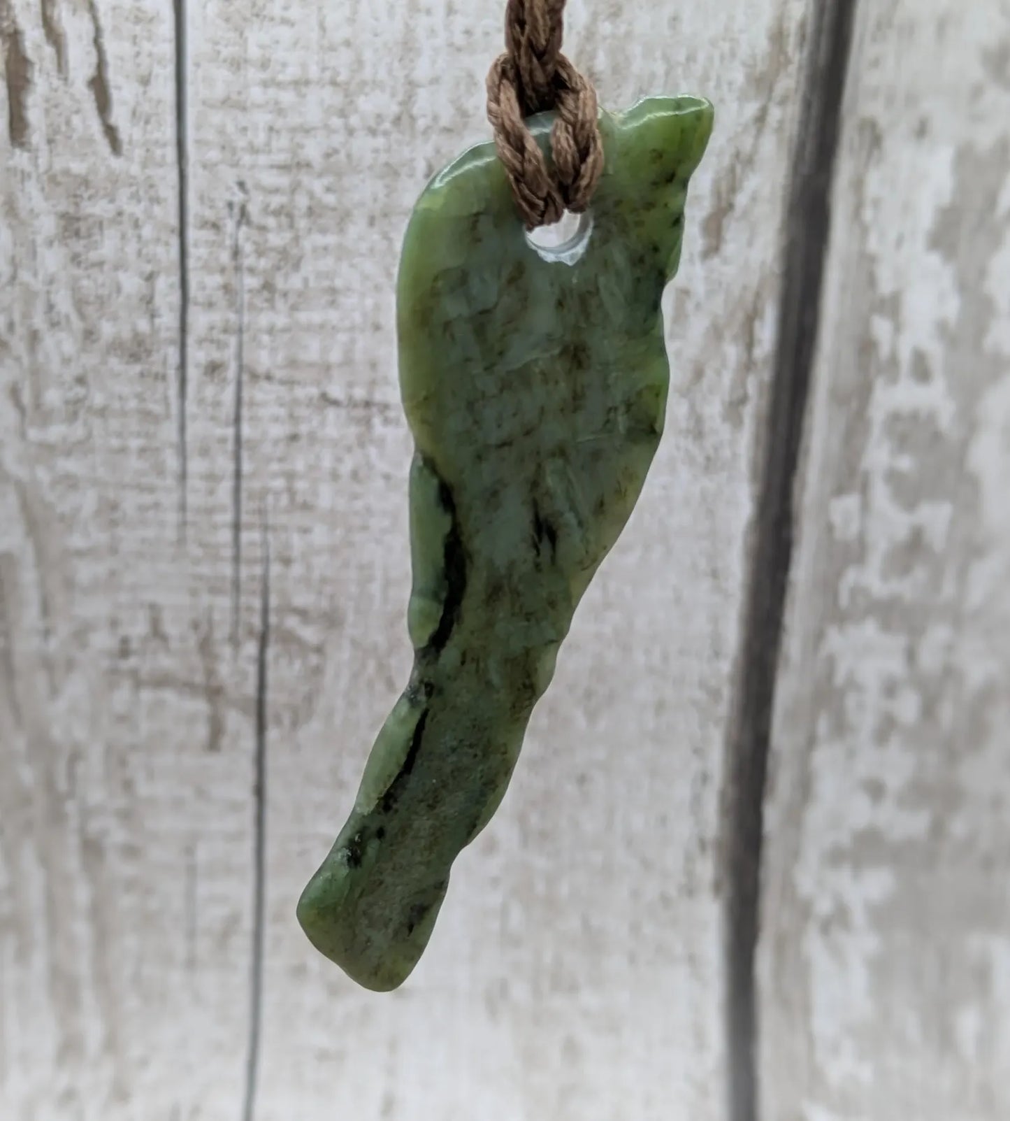 tumble polished New Zealand pounamu greenstone jade pendant.