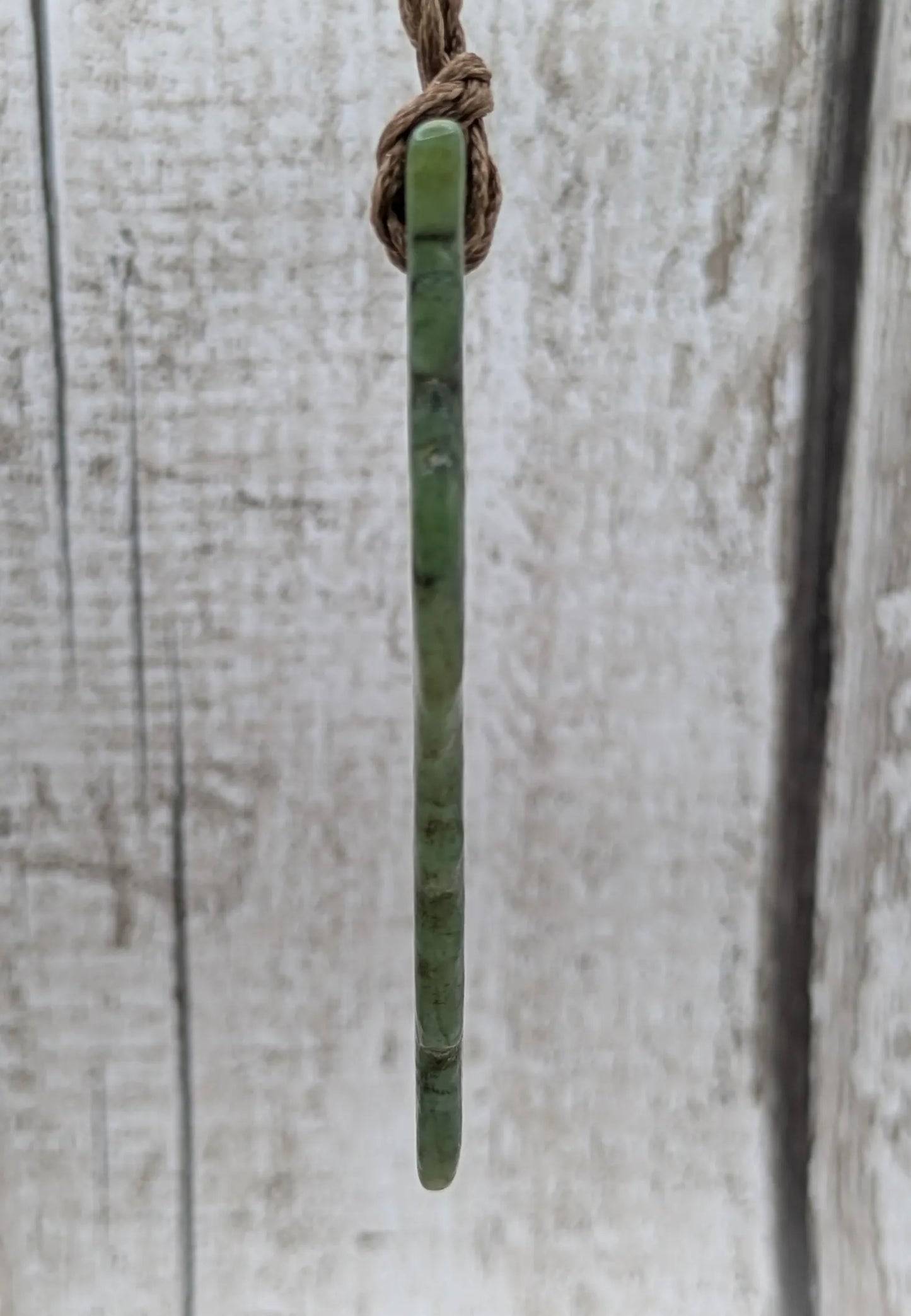 tumble polished New Zealand pounamu greenstone jade pendant.