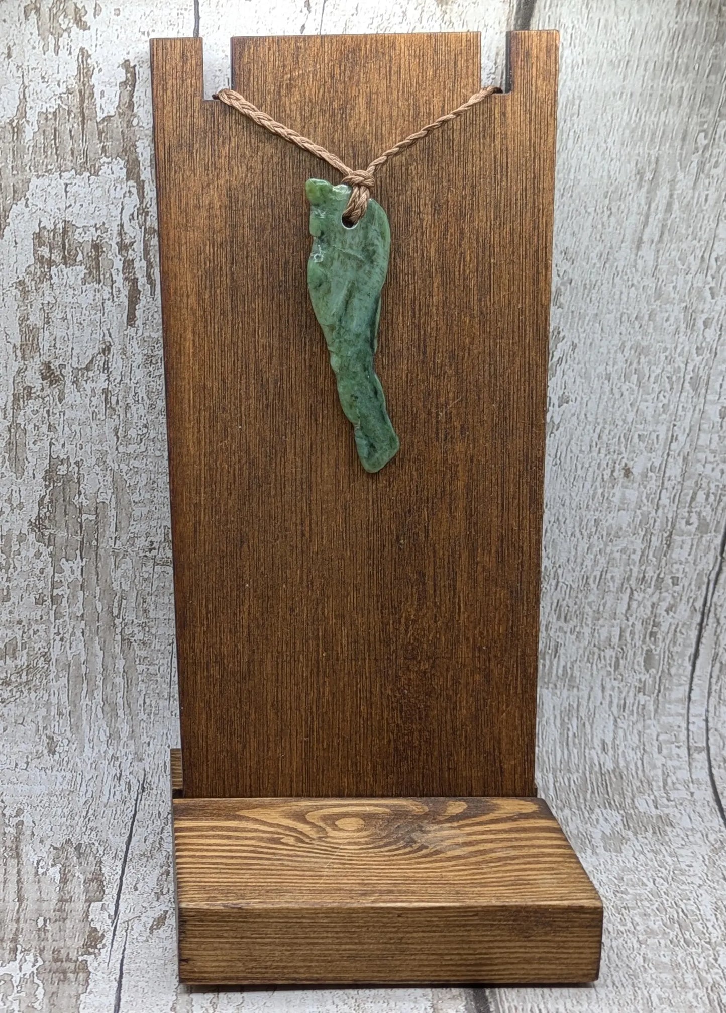 tumble polished New Zealand pounamu greenstone jade pendant.