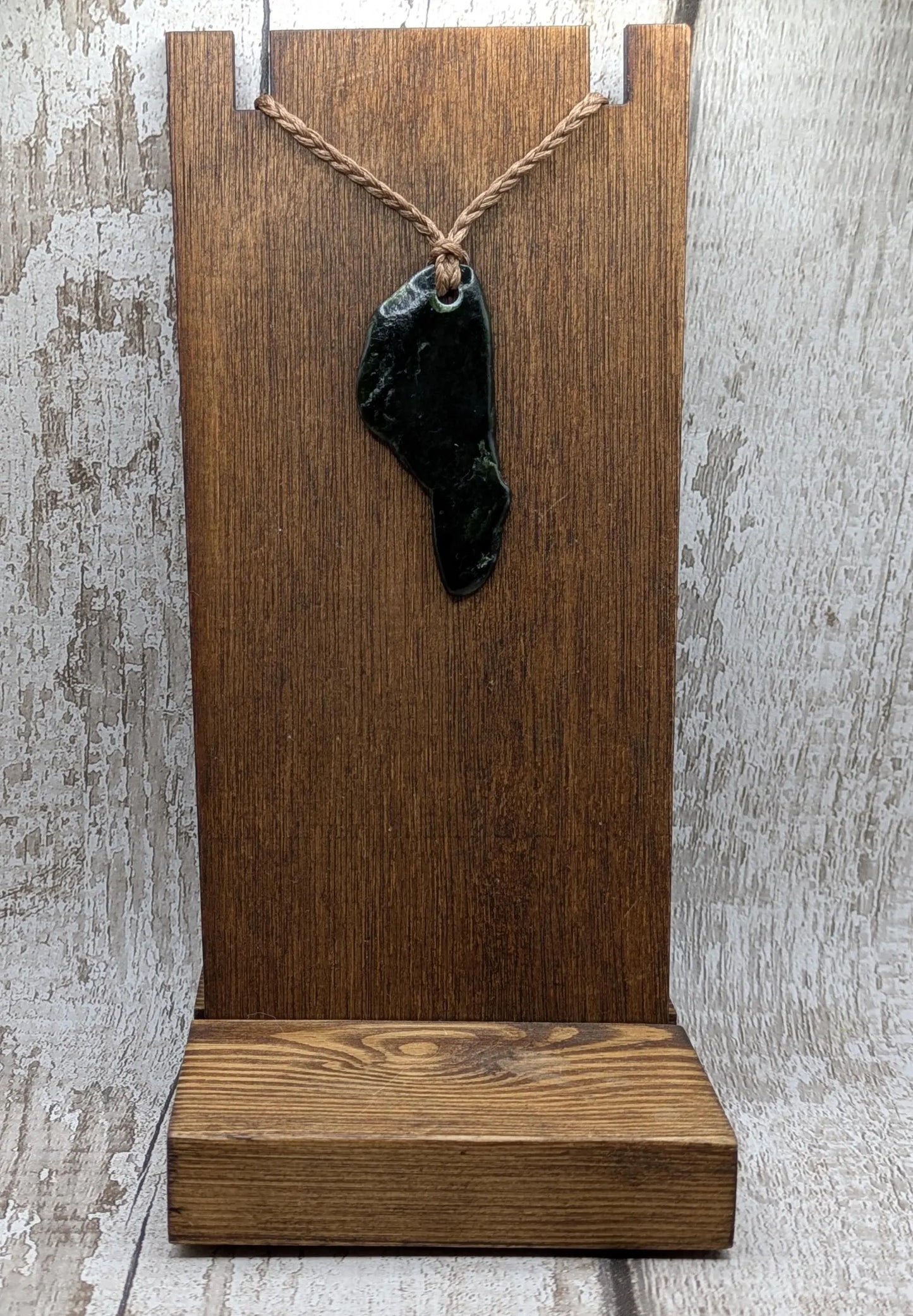Tumble polished New Zealand greenstone jade pendant.