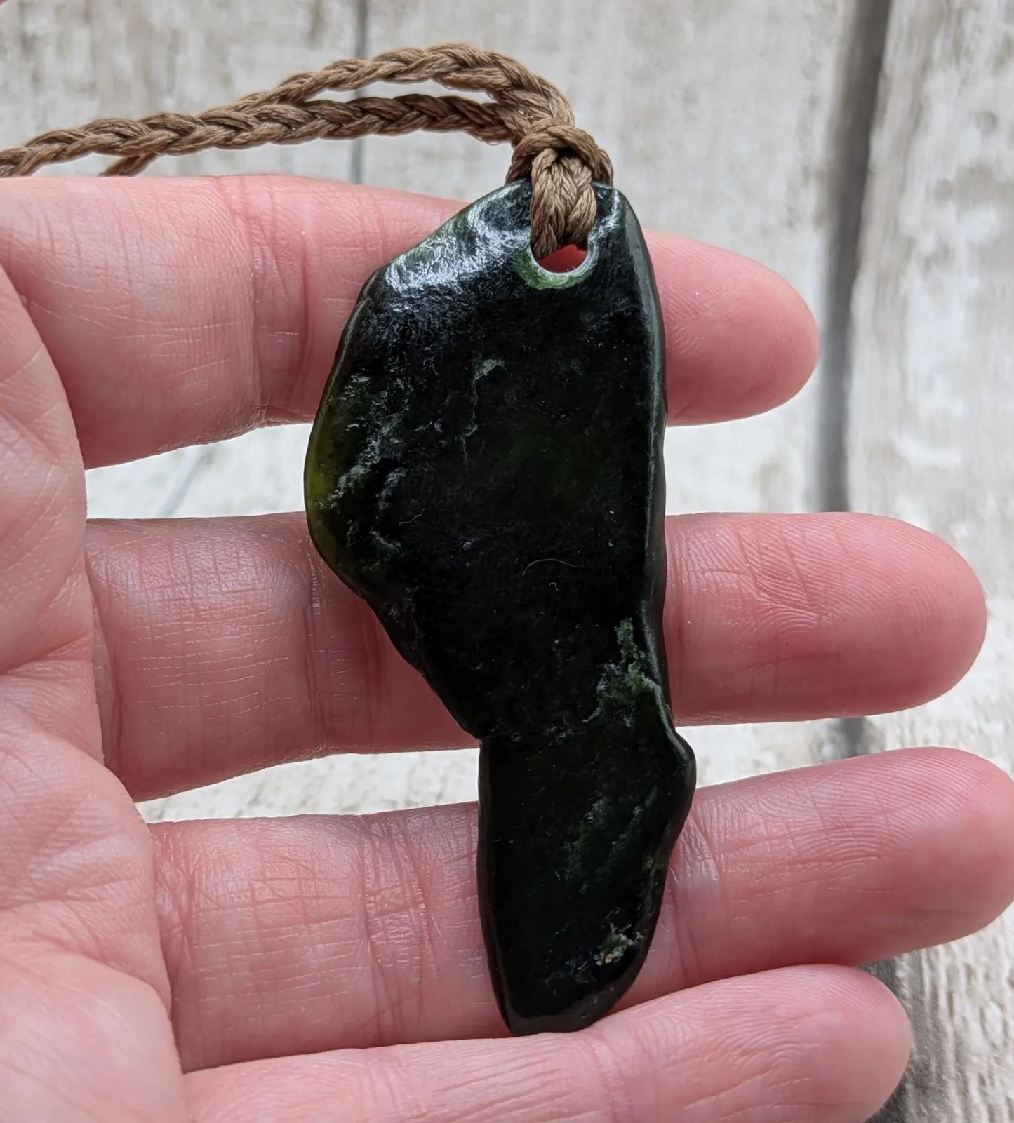 Tumble polished New Zealand greenstone jade pendant.