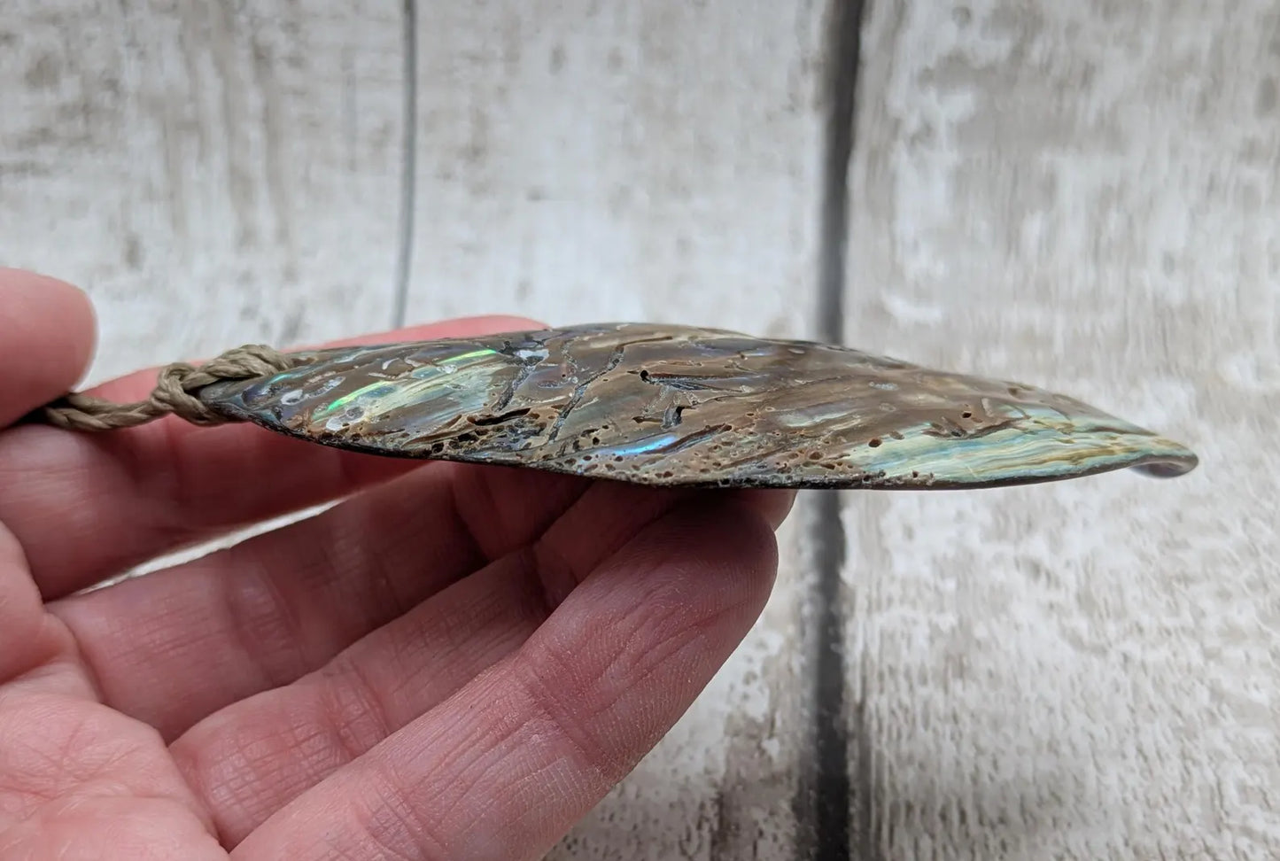 New Zealand free form naturally tumbled Pāua shell pendant.