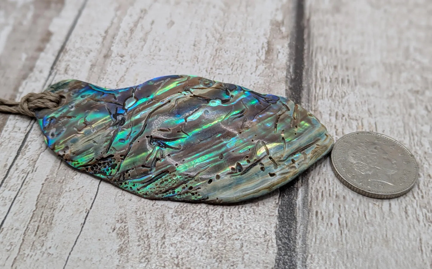 New Zealand free form naturally tumbled Pāua shell pendant.