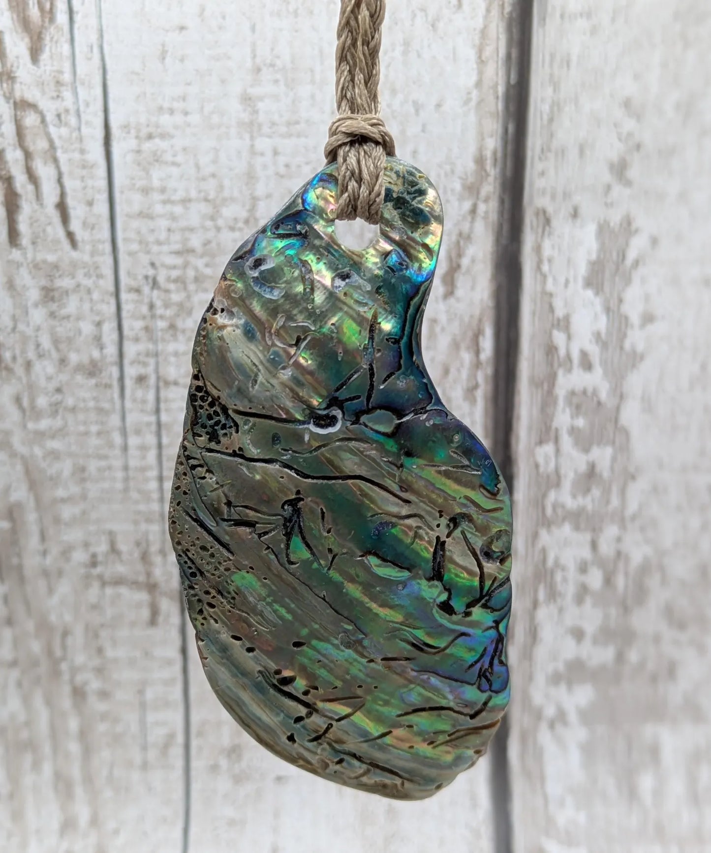 New Zealand free form naturally tumbled Pāua shell pendant.